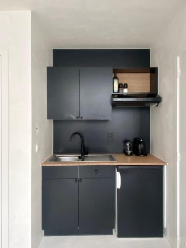 a kitchen with a sink and a counter top at Edville Studio in Ghent