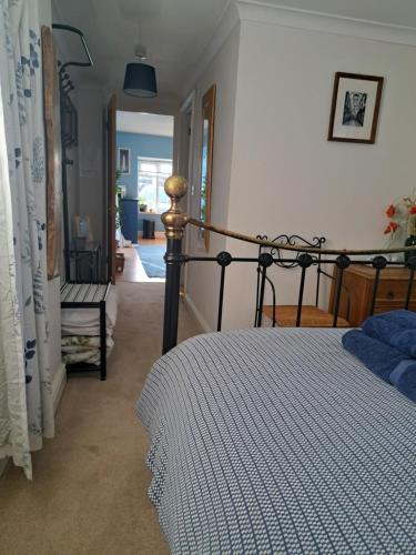 a bedroom with a bed and a chair in it at The Summer Room in Norwich
