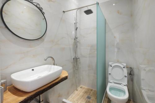 a bathroom with a sink and a toilet at Bertos Balcony In The Heart Of Canal D Amour in Sidari