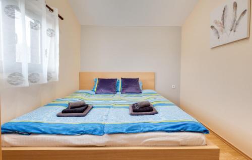 a bedroom with a large bed with purple pillows at Kuća za odmor MILA in Podgorje
