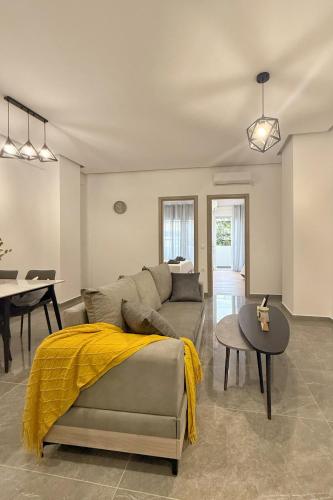 a living room with a couch and a table at Cozy Home With Cooking in Piraeus
