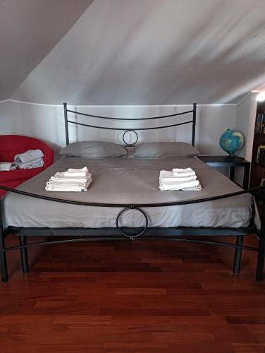 a bedroom with a bed with two towels on it at Mansarda Open Space in Ciampino