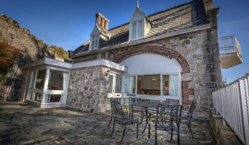 a stone house with a table and chairs at Château Rhianfa in Menai Bridge