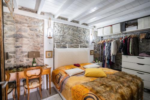 a bedroom with a bed and a desk with a chair at Casa Neverland in Vila Baleira