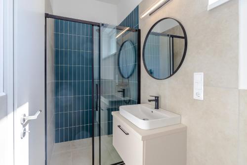 a bathroom with a sink and a mirror at Nemes Apartment The Great - Petite in Nemesvita