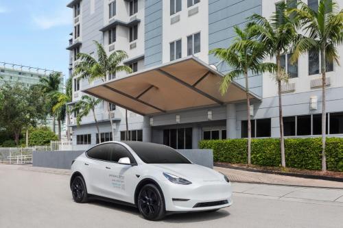 a white tesla car parked in front of a building at SpringHill Suites Miami Downtown/Medical Center in Miami