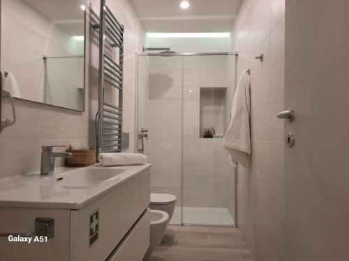 a bathroom with a sink and a toilet and a shower at Suite Naviglio Grande in Milan