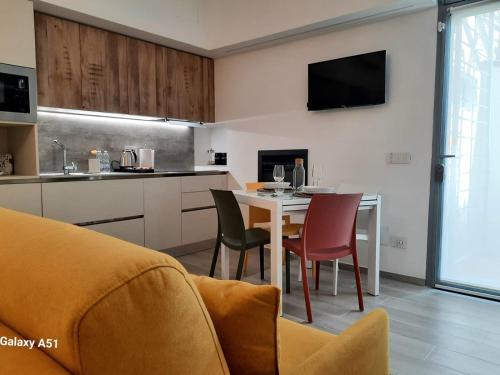 a kitchen and dining room with a table and chairs at Suite Naviglio Grande in Milan