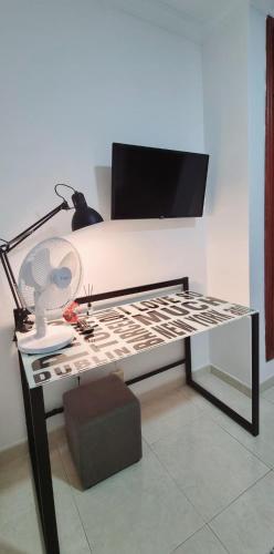 a bedroom with a bed with a desk with a lamp at ALMar We Go! Alcalá - Habitaciones Privadas en piso compartido Frente al Mar - Private Rooms in shared Apartment in Alcalá