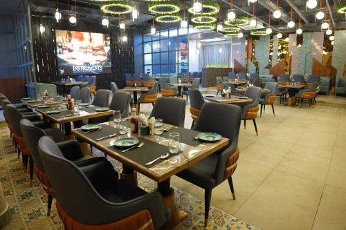 a dining room with wooden tables and chairs at The Pearl Petal in Rohtak