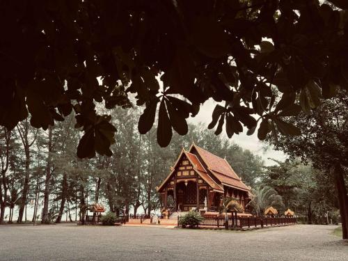 a large wooden building in the middle of a park at Turtle Tales-Tahnu,Thaimueang beach,Phang-Nga in Thai Muang