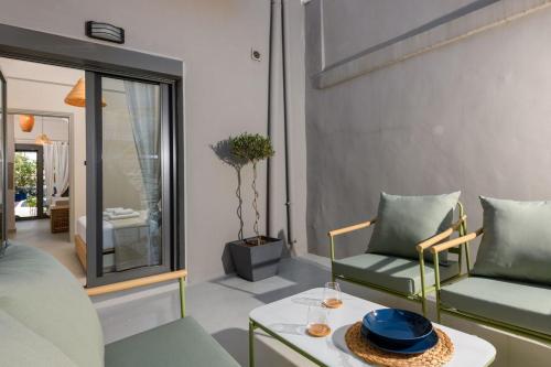 a living room with two chairs and a table at The Old Port in Limenas
