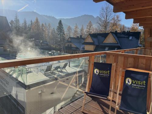 a view of a deck with a view of a mountain at VisitZakopane - Royal Resort Wellness & SPA in Zakopane