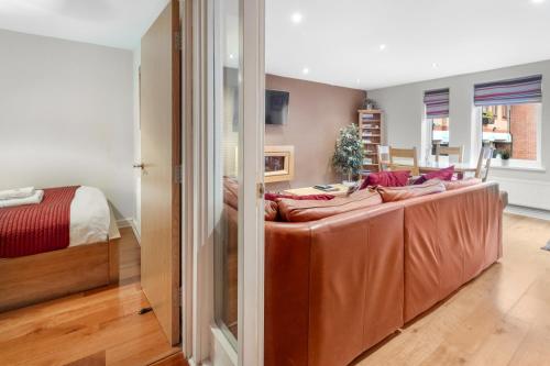 a large couch in a room with a bed at The Jewellery Suites Birmingham in Birmingham