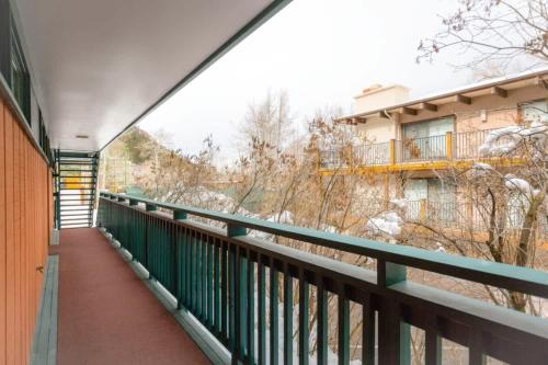 a balcony with a green railing and a building at Comfort & Location - 2 BR, 2BA - Steps to Town in Aspen