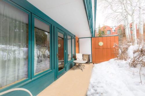 a house with a balcony with snow on the ground at Comfort & Location - 2 BR, 2BA - Steps to Town in Aspen