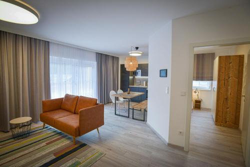 a living room with a chair and a table at 1.000m Ferienwohnungen in Semmering