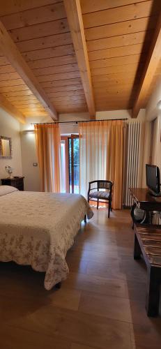a bedroom with a bed and a wooden ceiling at B&B Spring in Perugia