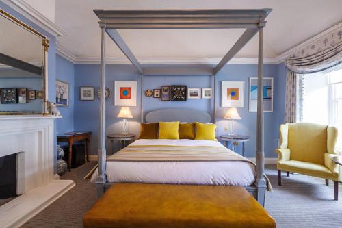 a bedroom with a canopy bed and a fireplace at The Assembly House in central Norwich in Norwich