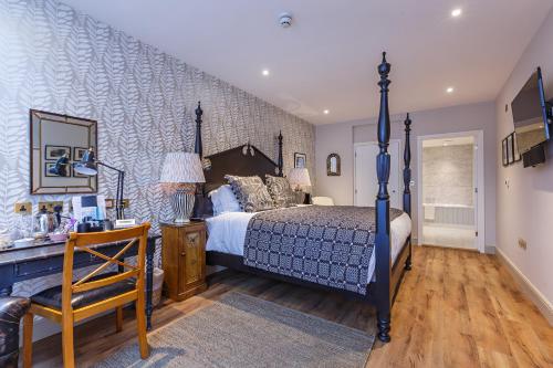 a bedroom with a bed and a desk with a chair at The Assembly House in central Norwich in Norwich