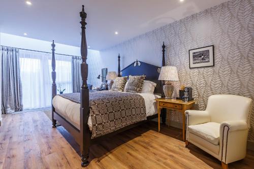 a bedroom with a bed and a chair at The Assembly House in central Norwich in Norwich
