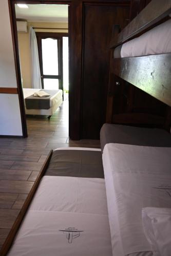 a bed in a room with a bunk bed at Hotel Mirador del Dayman in Termas del Daymán