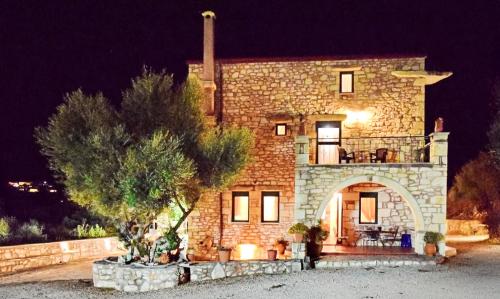 a large brick building with a balcony on top of it at Chania's Diamond Villas - Aqua Bliss with Private Pools in Gavalochori