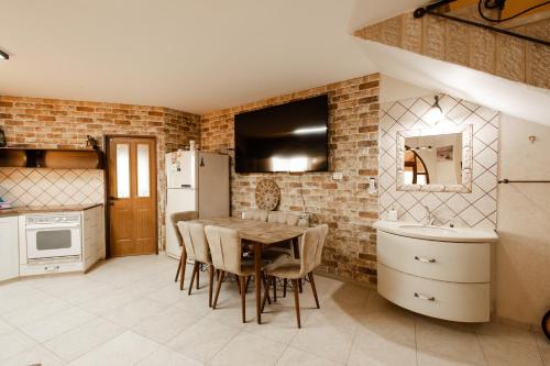 a kitchen with a table and chairs and a refrigerator at Ram La-nof in Majdal Shams