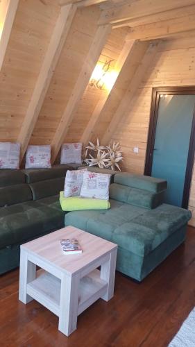 a living room with a couch and a table at CABANA 365 in Braşov