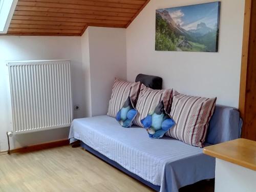 a living room with a couch with pillows at Bauernhof Gorihof in Aschau im Chiemgau