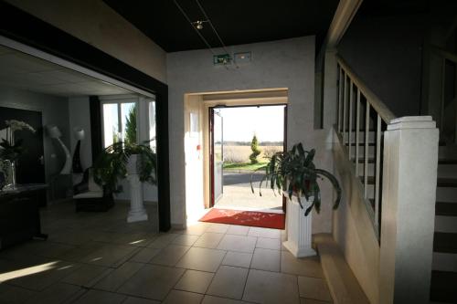 a hallway with a door leading to a yard at Hotel Air-lane in Saint-Léger-sous-Brienne