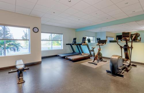 a gym with several treadmills and elliptical machines at Tru By Hilton Panama City Beach in Panama City Beach