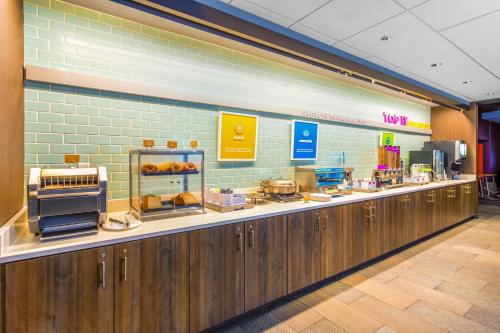 a bakery counter with a lot of food on it at Tru By Hilton Panama City Beach in Panama City Beach