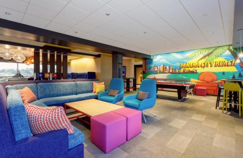 a waiting room with couches and a pool table at Tru By Hilton Panama City Beach in Panama City Beach