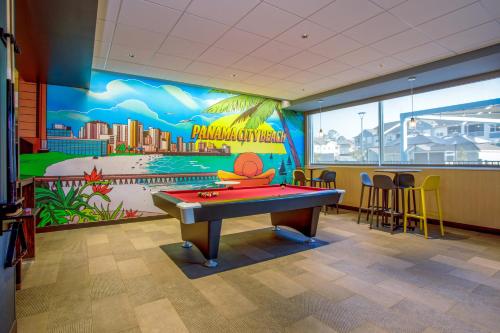 a pool table in a room with a mural at Tru By Hilton Panama City Beach in Panama City Beach