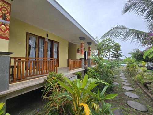 a house with a porch and some plants at Kelingking BMS Penida Hills Villa in Nusa Penida