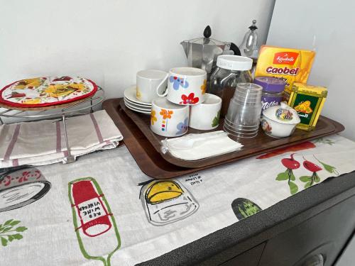 a table with a tray with cups and plates on it at Chez Mia in Fès