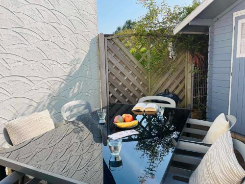 a table with a bowl of fruit on a patio at Ferienhaus Bach in Dorum Neufeld