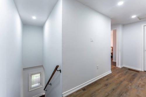 an empty room with white walls and wood floors at Whitby Family Retreat Comfort and Convenience in Whitby