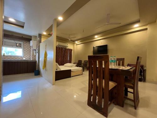 a room with a dining table and a living room at Shree jee's House in Vrindāvan