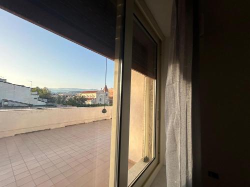 a window in a room with a view of a building at La terrazza in Marina di Gioiosa Ionica