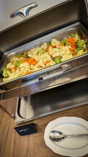 a pan filled with vegetables on top of a table at Hotel Wisła Premium in Wisła