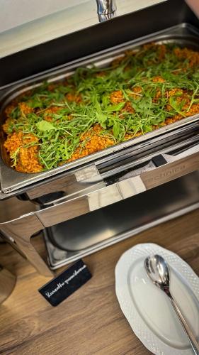 a pizza in a pan on a table with a plate at Hotel Wisła Premium in Wisła