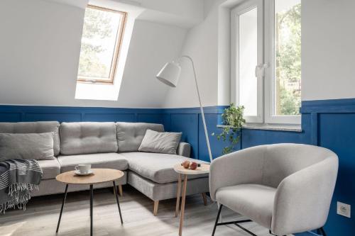 a living room with a couch and a chair at Pensjonat Vyspa Gdynia in Gdynia