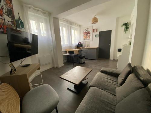 ein Wohnzimmer mit Sofa und Tisch in der Unterkunft Appartement Alfortville proche métro et RER in Alfortville
