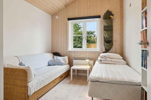 a small room with a bed and a window at Lovely Holiday Home In Nykøbing Sjælland in Nyrup