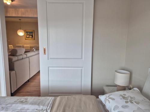 a bedroom with a door leading to a living room at Apartman Lončar Posušje in Posušje
