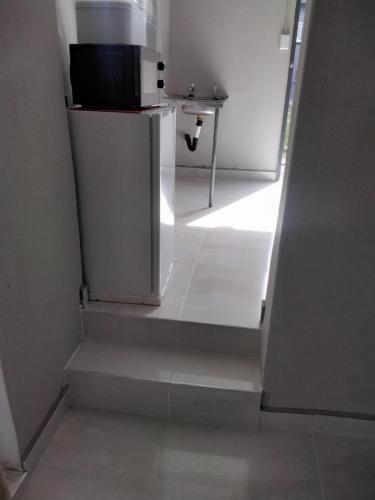 a stairway with a white refrigerator in a room at Vumasky self catering in Ladysmith