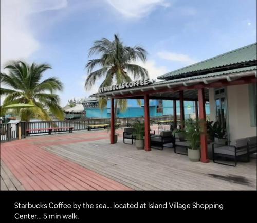 a pavilion with chairs and palm trees on a boardwalk at Mystical Studios King in Ocho Rios