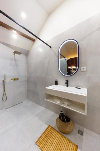 a bathroom with a sink and a mirror at Serenity Villa - Détente & Chill in Cormeilles-en-Parisis